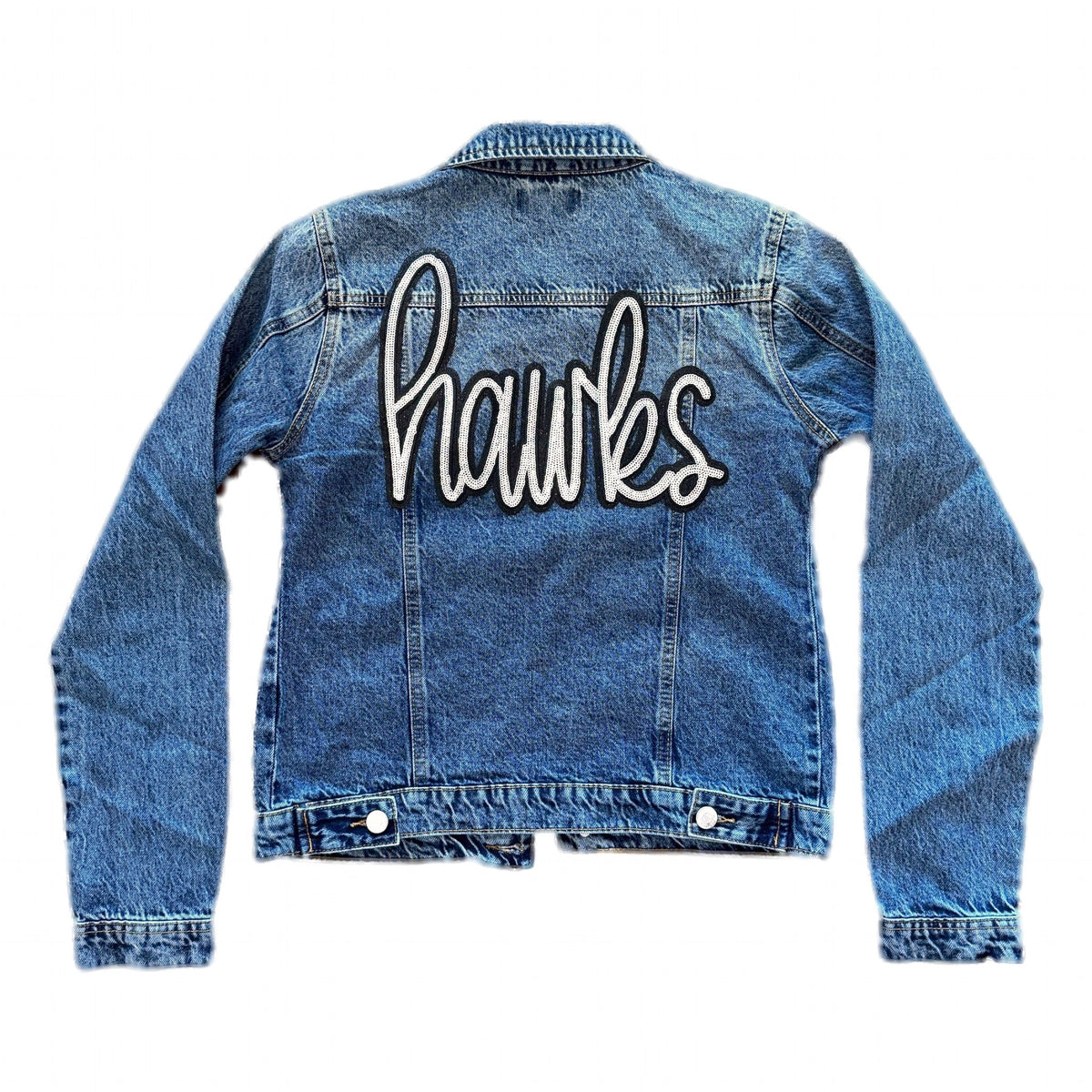 Back of medium-wash denim jacket with sequin hawks script patch