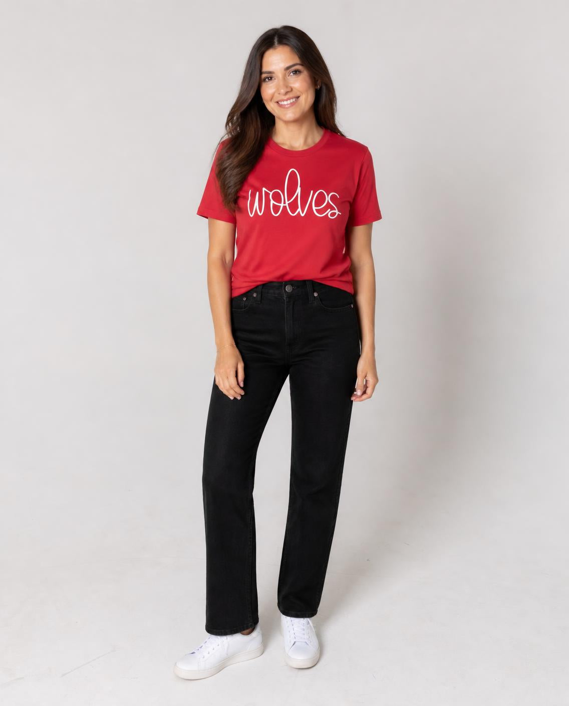 Woman wearing the scarlet cursive wolves tee with black jeans